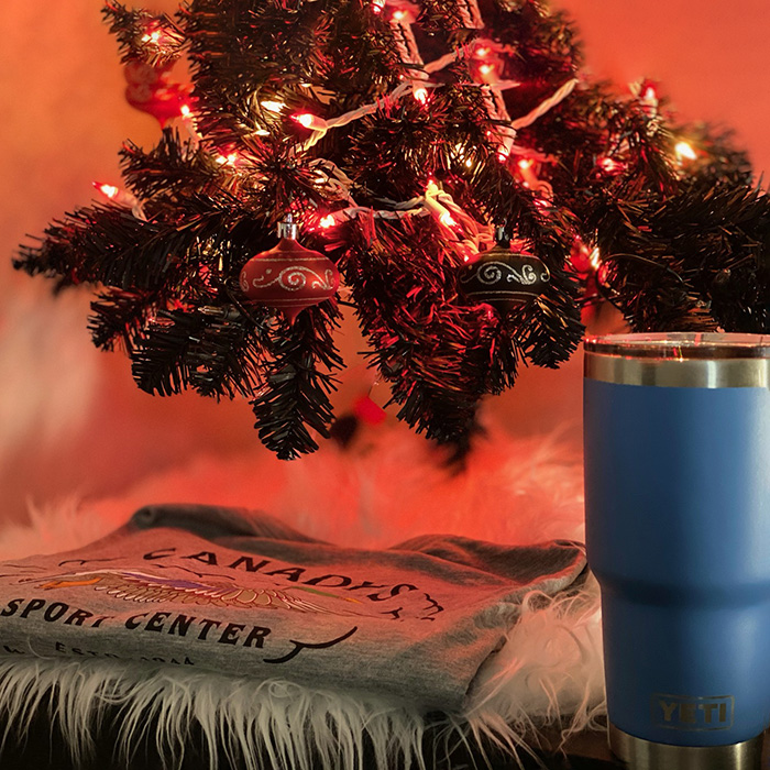 Yeti tumbler and Canady's t-shirt displayed under Christmas tree.